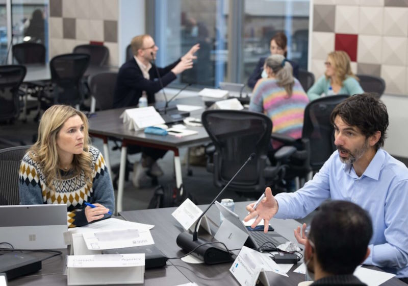 A group of executive participants work together in a classroom at the Telfer Executive campus.