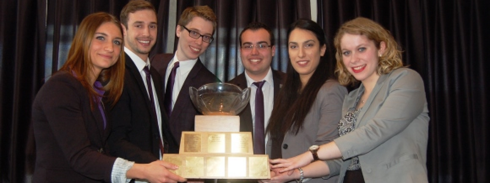 winning team holding the Michel Cloutier Trophee
