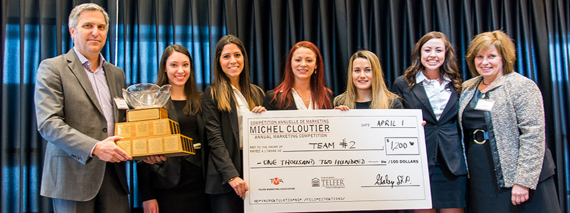 Michel Cloutier Winners Holding a Big Cheque