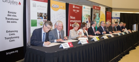 Photo of representatives signing the agreement