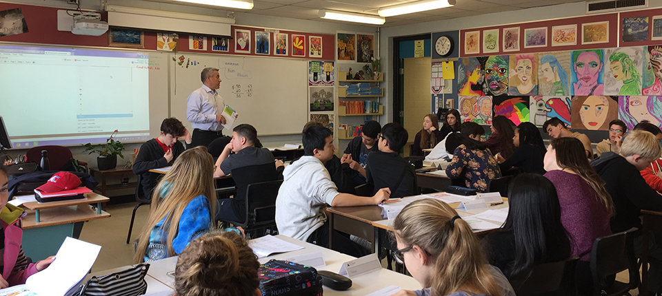 Assistant Dean Alain Doucet in a classroom teaching a grade 8 class