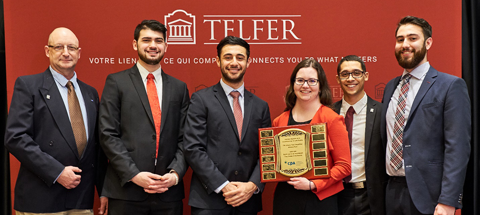 Winners of the CPA Accounting Case Competition holding their plaque