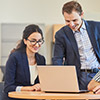 Two people using computer