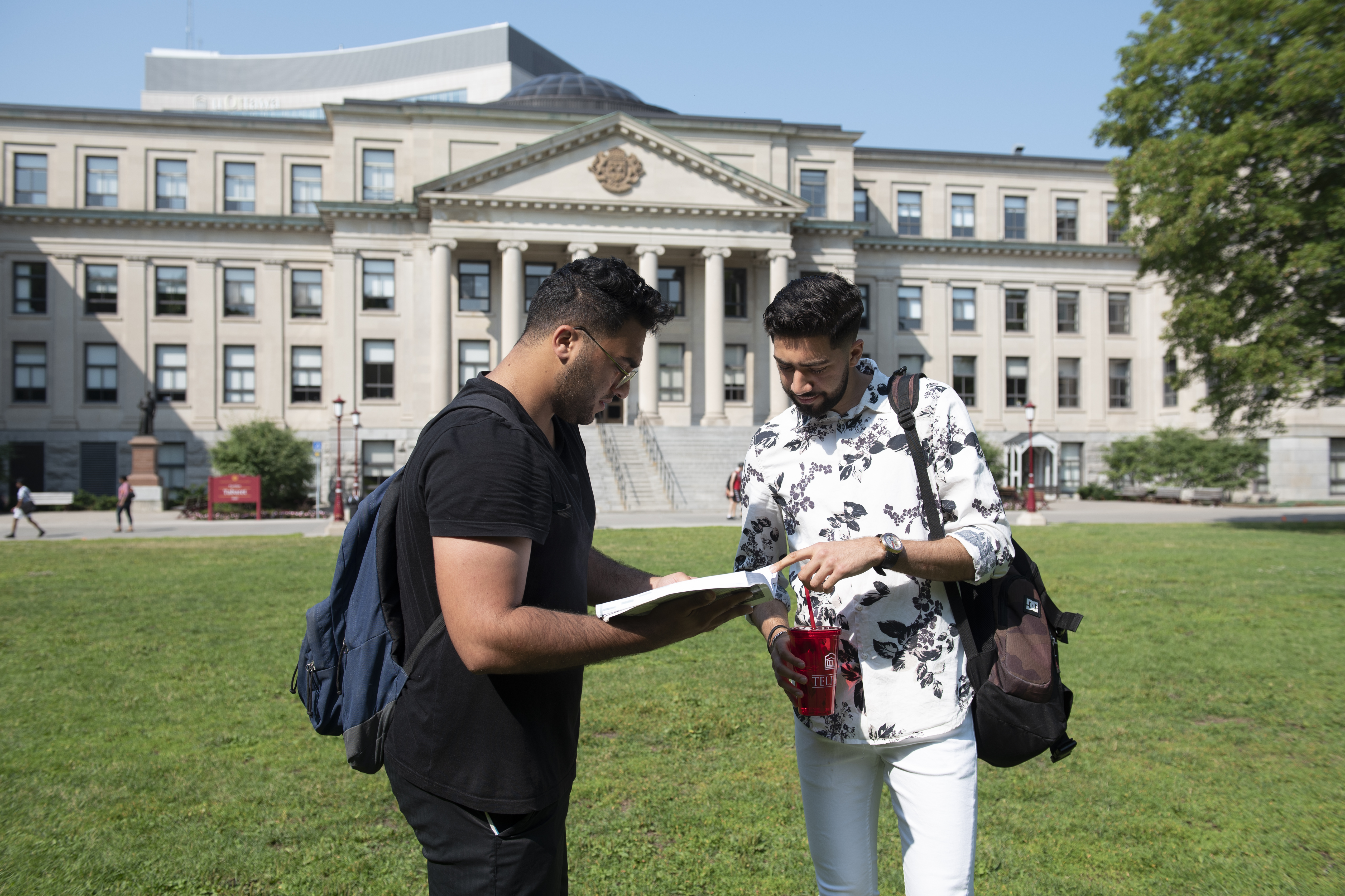 Telfer students studying on the Tabaret lawn with their textbooks