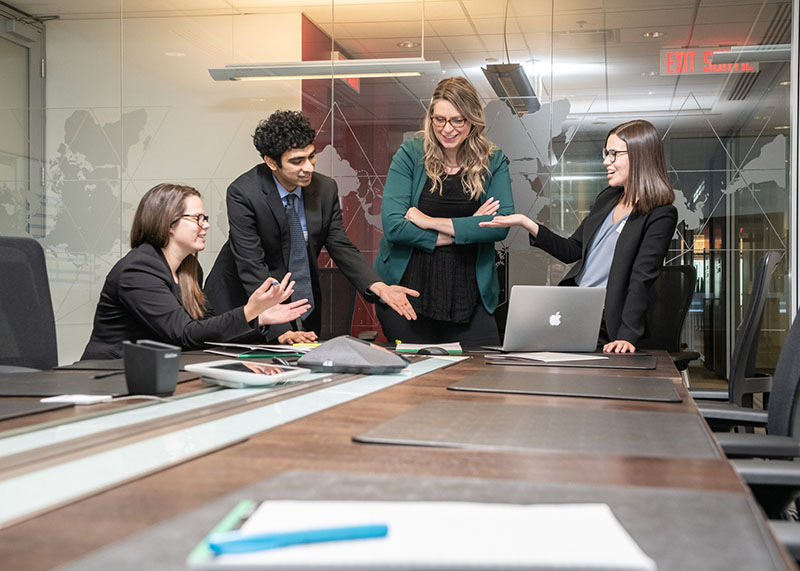 students in a conference room discussing notes placed on the table