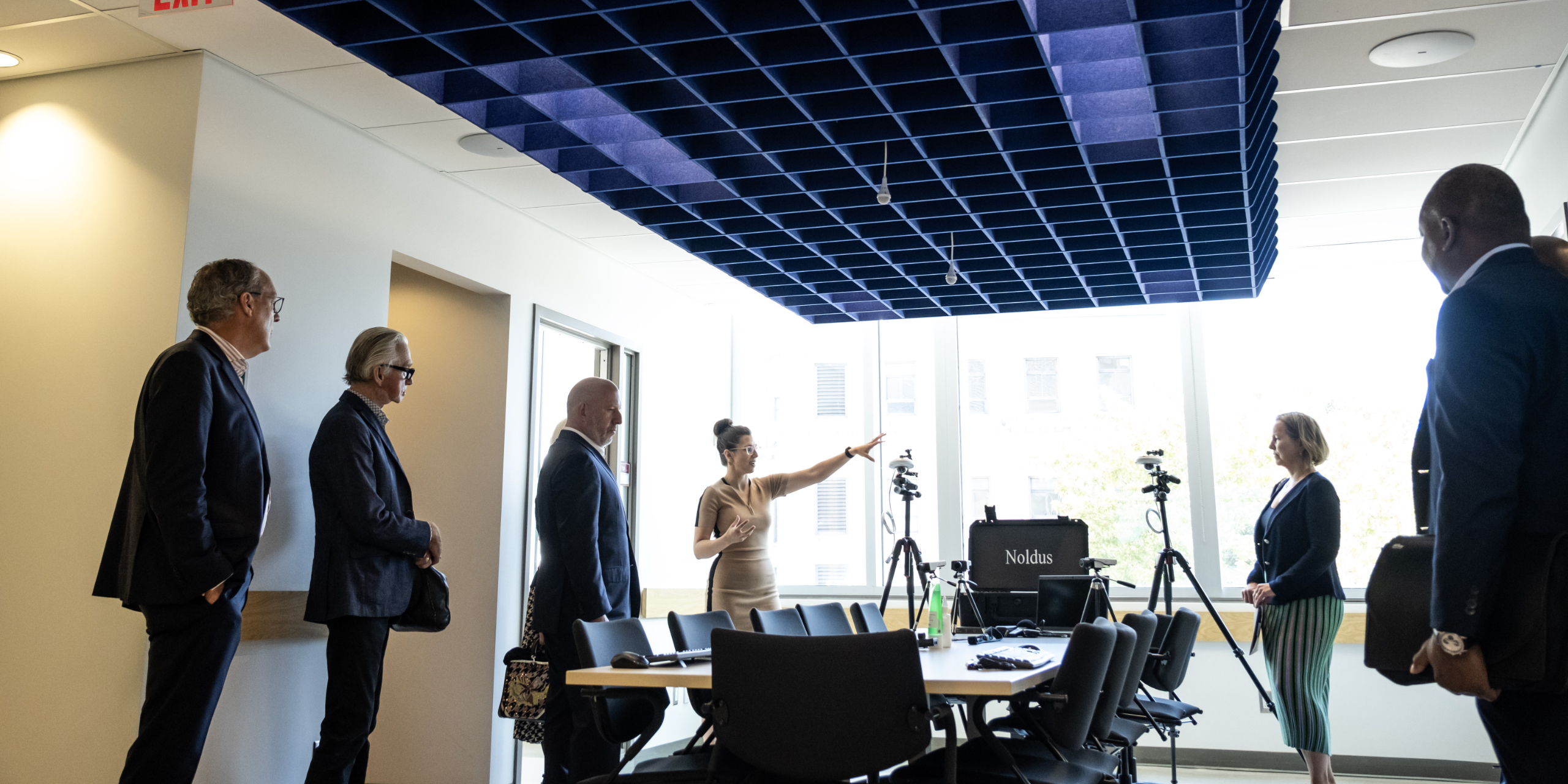 A group of business people standing around a table