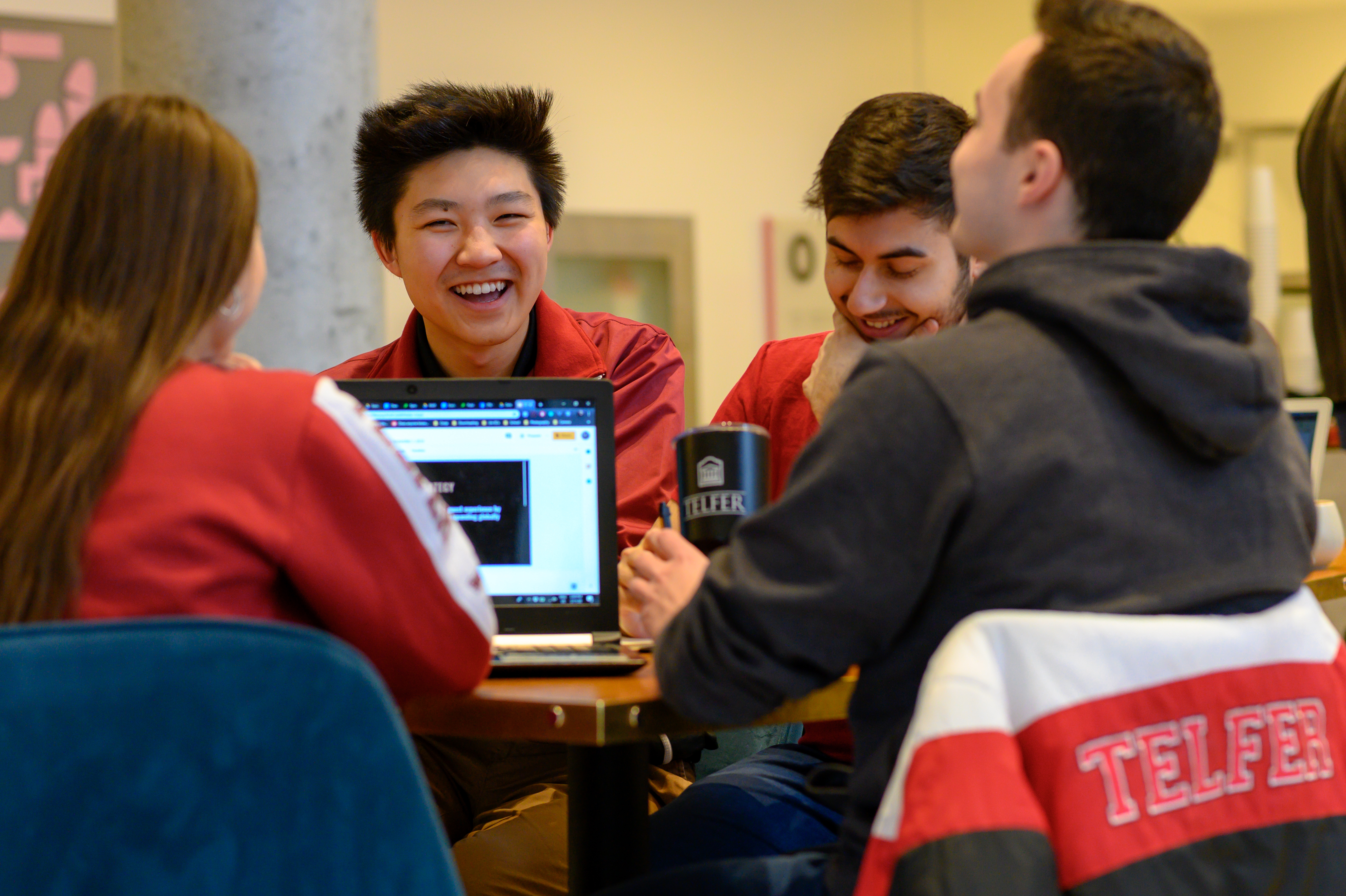 Group of Telfer students studying and laughing together